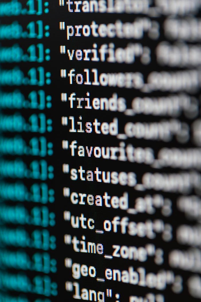 about-us-01 Extreme close-up of computer code displaying various programming terms and elements.